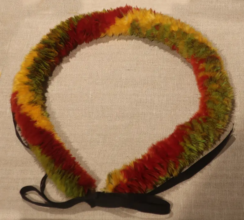 A feather lei of orange and black feathers in the Lyman Museum